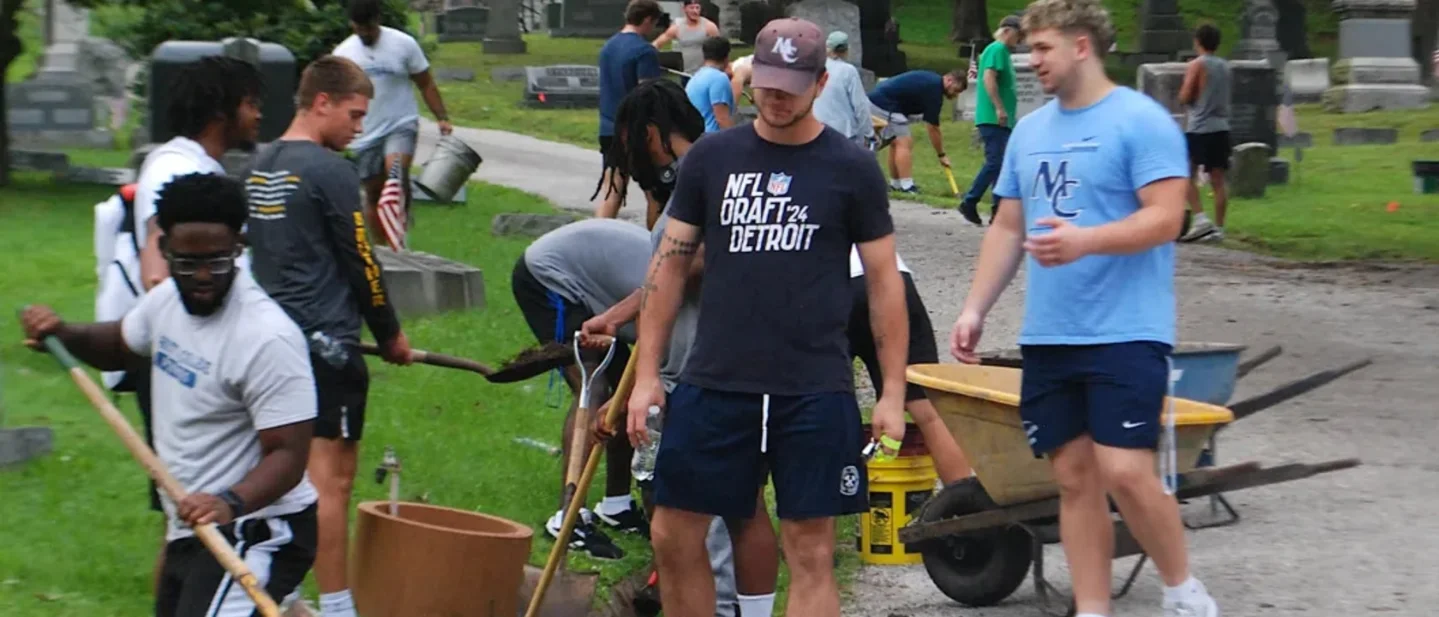 At Oak Grove Cemetery, a football team traded the field for drains and brickwork