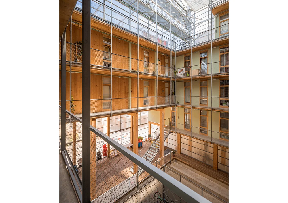 Barcelona's La Borda fits 28 homes around a shared courtyard