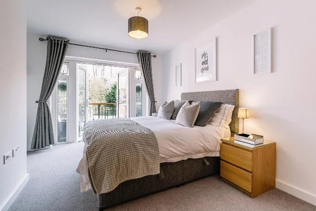 Minimalist modern bedroom with white walls and uncluttered furniture