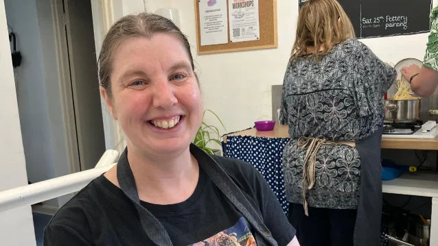 Emma smiles in a Workbridge cooking session
