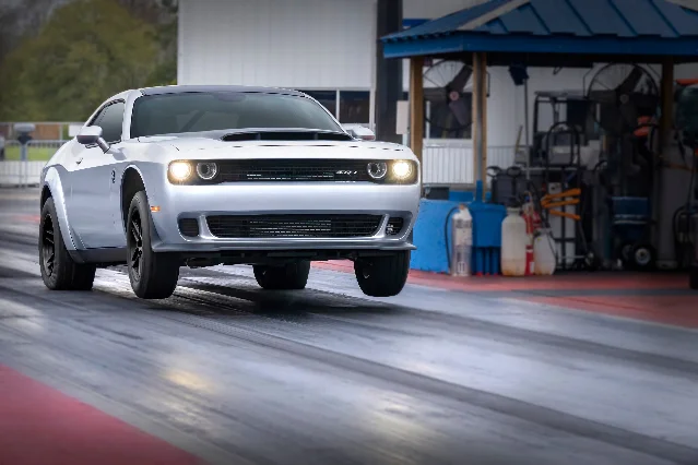 A silver 2023 Dodge Challenger SRT Demon 170 with its hood scoop visible, parked on a drag strip