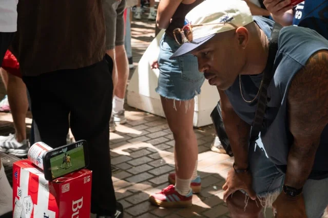 Fan watches World Cup on a phone in Pioneer Square