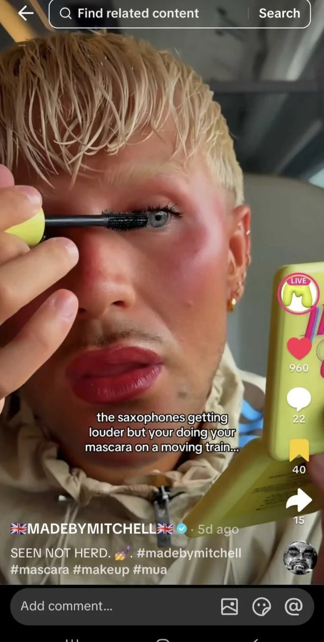 TikTok creator applying mascara on a train — "the saxophones getting louder" trend