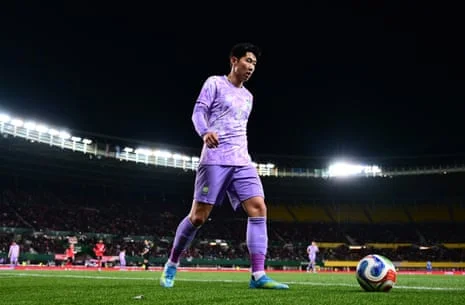 Son Heung-min of Korea Republic, arms wide, stadium lights behind