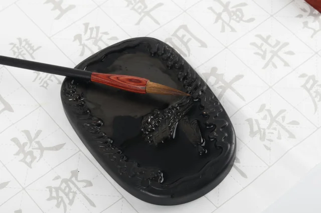 Traditional Chinese ink stone and brush for calligraphy writing|砚台与毛笔,象征今日命理知识的沉淀与传授