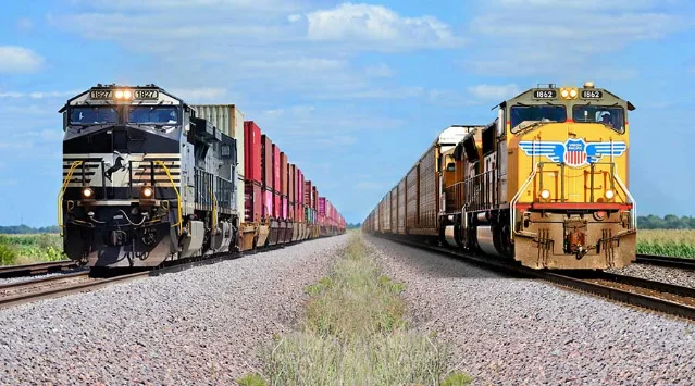 Norfolk Southern (left) and Union Pacific freight locomotives on parallel tracks