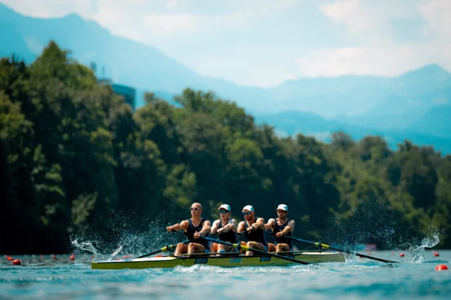 Rowers carry a racing shell beside the Bosbaan during a World Rowing event.