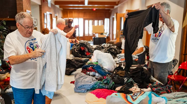 Volunteers sort donated clothing at St. Paul's United Methodist Church in Toledo.