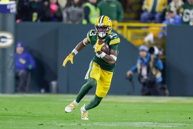 Dontayvion Wicks in a Packers uniform, mid-run after a catch against the Bears in 2024