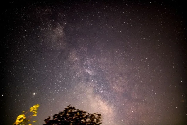 Milky Way over a dark landscape — cosmic backdrop for the week's Libra forecast