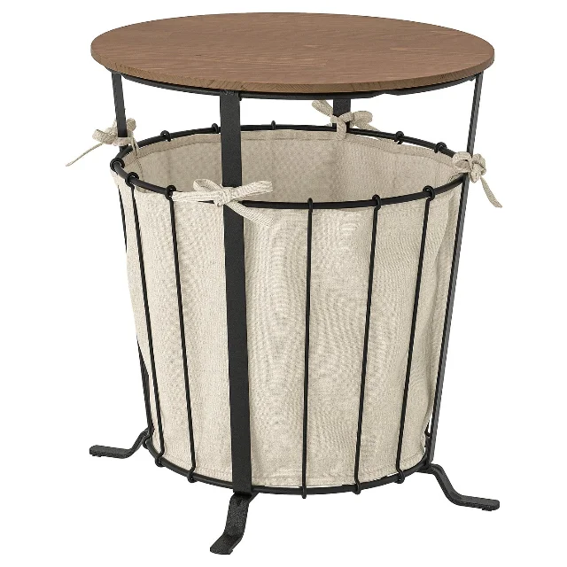 ÄNGESBYN storage table with round pine top, black metal frame, and cream fabric storage bag on white background