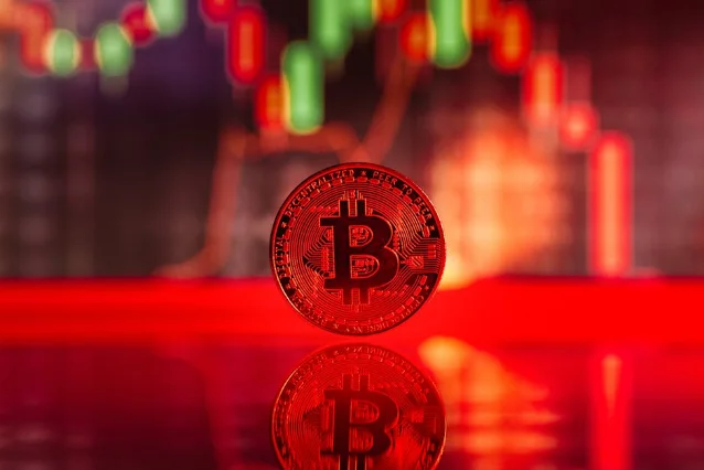 Bitcoin coin with red trading chart reflection