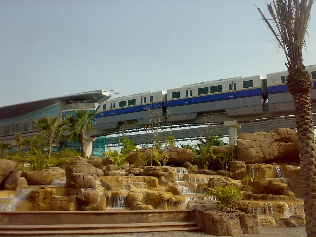 The Palm Jumeirah Monorail running along the trunk spine, approaching a station