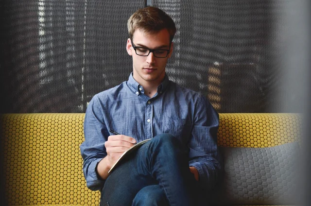 An entrepreneur planning a side business at a desk — the stage most Etsy and digital product sellers describe before their first sale