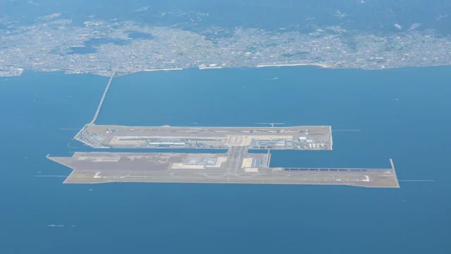Kansai International Airport's reclaimed islands sit offshore at the end of a long access bridge
