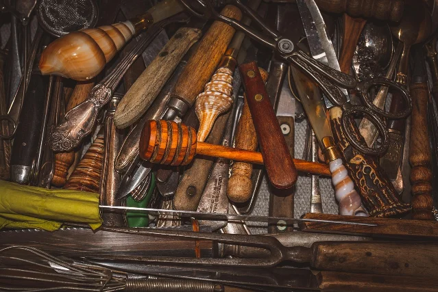 A crowded kitchen drawer filled with overlapping cooking utensils