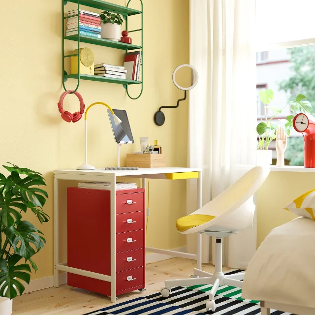 Red HELMER drawer unit in a compact home-office scene