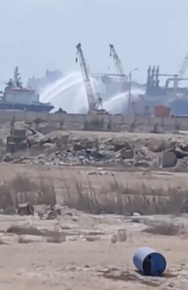 Water jets spray a gas tanker at Damietta port after a reported drone strike