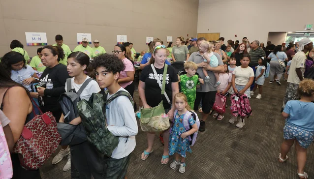 Families and volunteers gather inside the Back to School Community Giveback in Ocala.