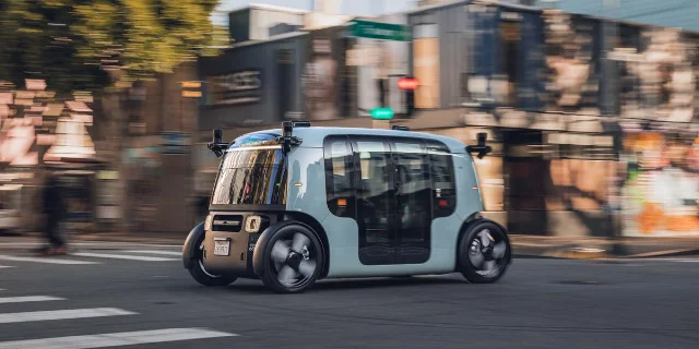 Zoox autonomous vehicle moving through a city intersection