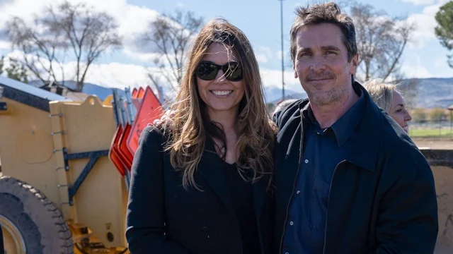 Christian Bale and his wife, Sibi, standing outdoors at the construction site