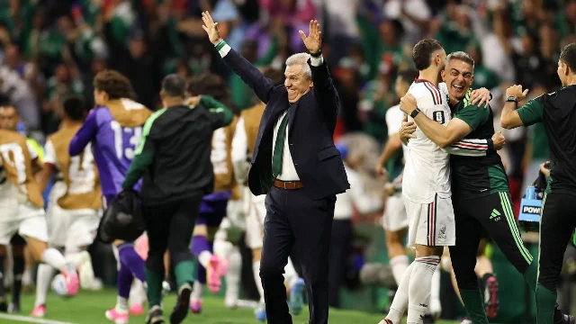 Mexico staff celebrate at the touchline