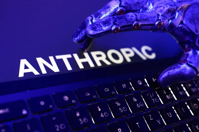 Illustration: Anthropic logo, a keyboard and a robotic hand — Reuters/Dado Ruvic illustration