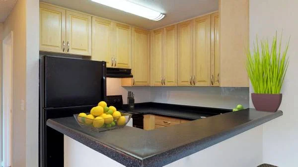 Crossroads at 5378 Clayton Rd, Concord — kitchen with light wood cabinets, granite counters, and bar seating
