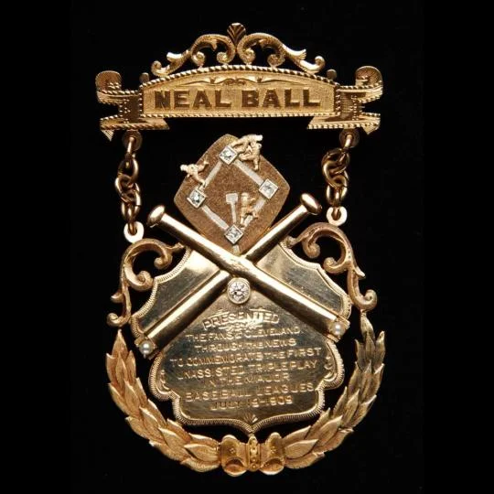 A gold commemorative medal bearing Neal Ball's name and honoring his unassisted triple play