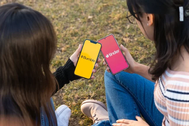 Two women using Bumble and Tinder apps on smartphones