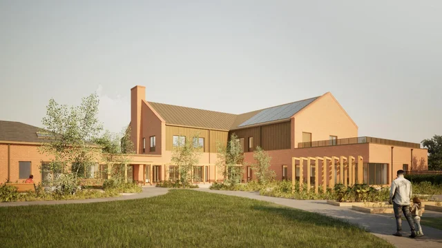a computer-generated image of a two-storey brick and timber hospice building with a garden in front