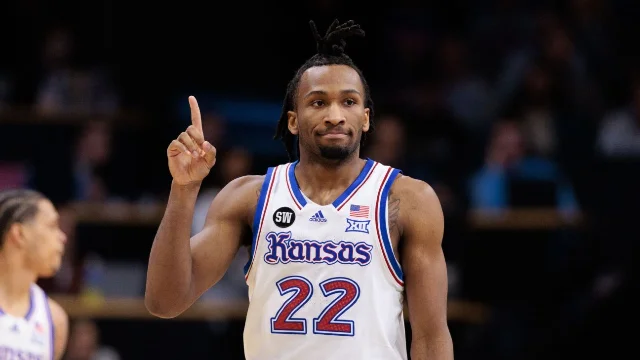 Darryn Peterson in Kansas No. 22 jersey pointing one finger at the camera