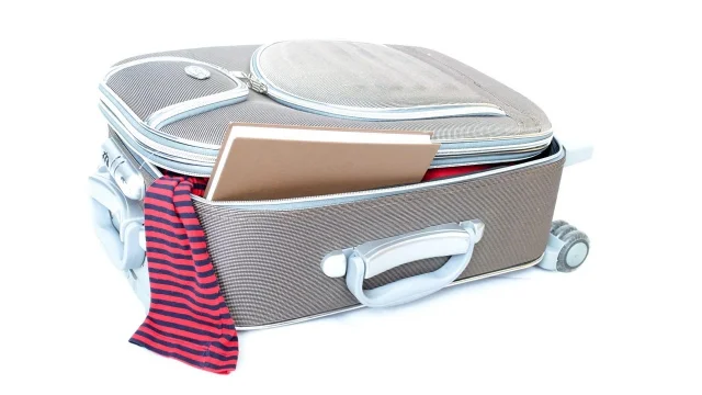 Open suitcase with clothes packed inside