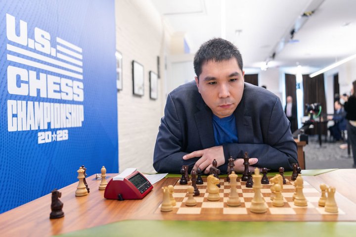 Wesley So at a chessboard with a U.S. Chess Championship backdrop