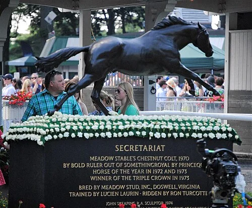 The bronze Secretariat statue at Belmont Park, wreathed in white carnations during the Belmont Stakes weekend
