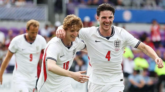 Declan Rice celebrates with Anthony Gordon after putting England ahead against Costa Rica in Orlando. Both are in white kit.