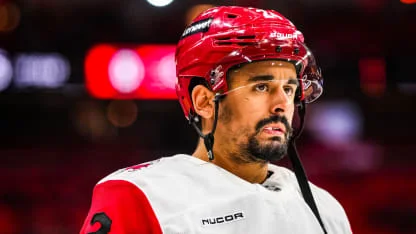 Seth Jarvis in a white Carolina Hurricanes jersey on the ice