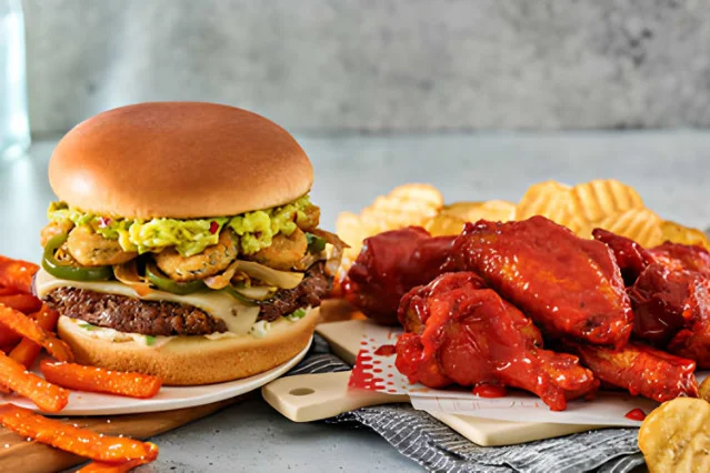 Burgers and wings on a restaurant table