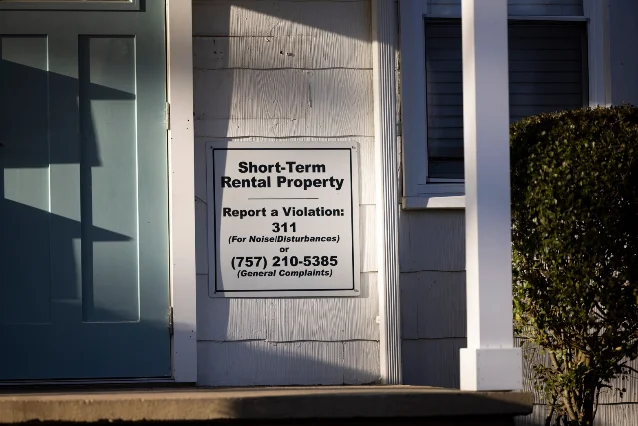Short-Term Rental property sign on a residence exterior