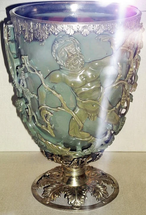 The Lycurgus Cup in reflected light, showing its green color and openwork figure carving