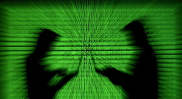 Silhouettes beside projected computer code