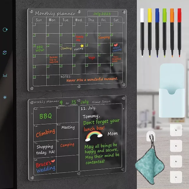 Two transparent acrylic dry-erase planner boards with magnetic corners mounted side by side with markers and an accessory caddy.