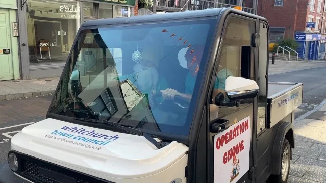 The small electric "gnome-mobile" carries Operation Gnome planters through Whitchurch.