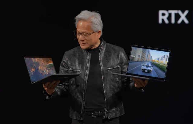 NVIDIA CEO Jensen Huang holds up two RTX Spark laptops at GTC Taipei / Computex 2026