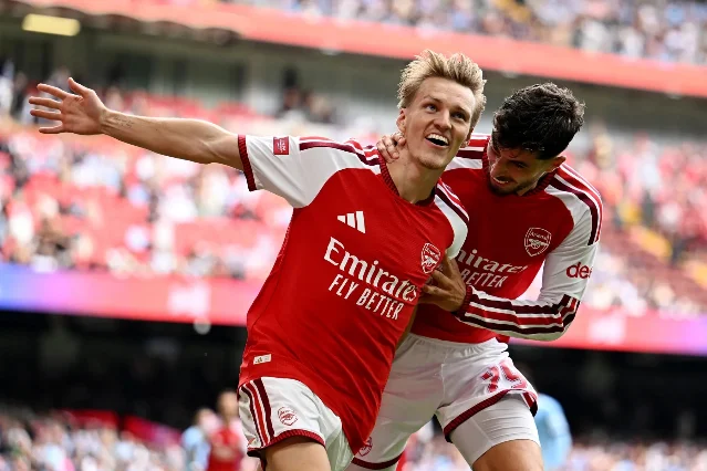Martin Odegaard celebrates after scoring Arsenal's third goal against Manchester City