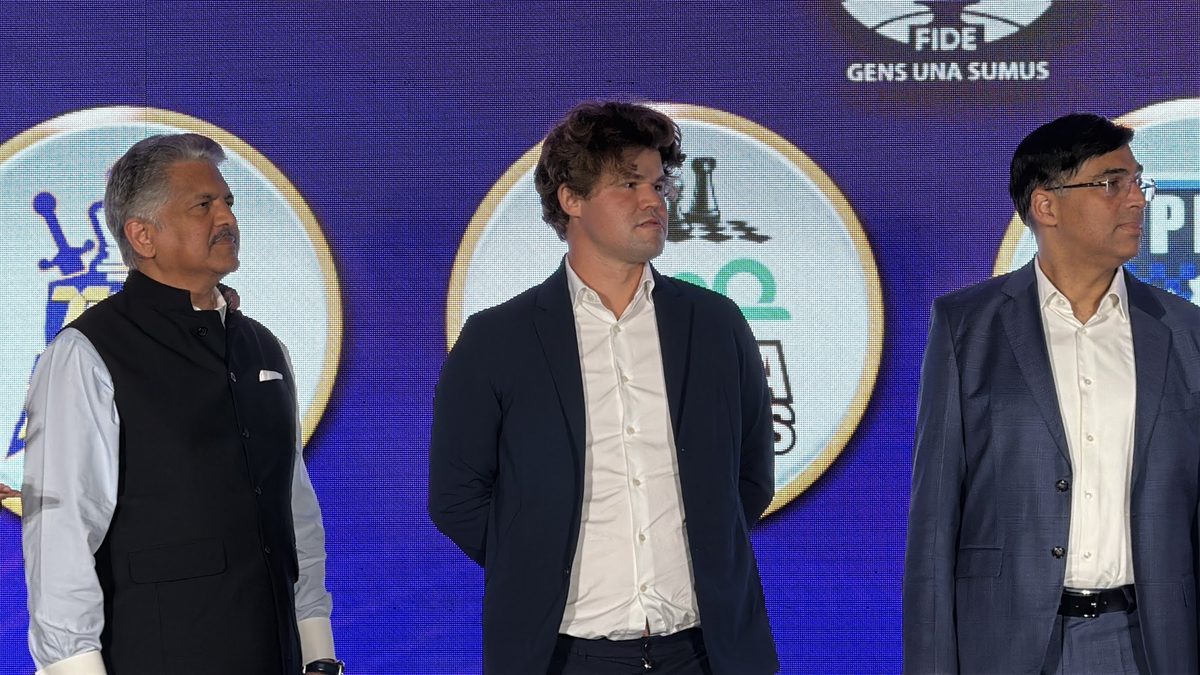 Anand Mahindra, Magnus Carlsen, and Viswanathan Anand on stage at the Global Chess League opening ceremony