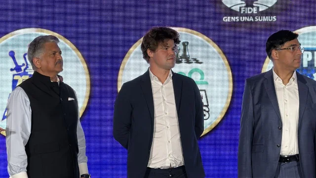 Anand Mahindra, Magnus Carlsen, and Viswanathan Anand on stage at the Global Chess League opening ceremony