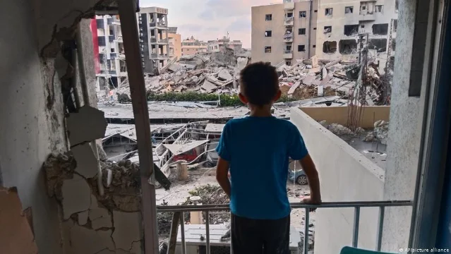 A boy looks through a hospital window at a destroyed building in Tyre, Lebanon, June 1, 2026