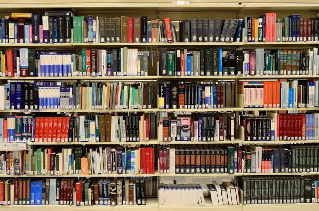 Books arranged across a large library wall