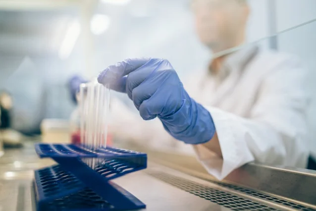 Scientist examining samples in biotech laboratory